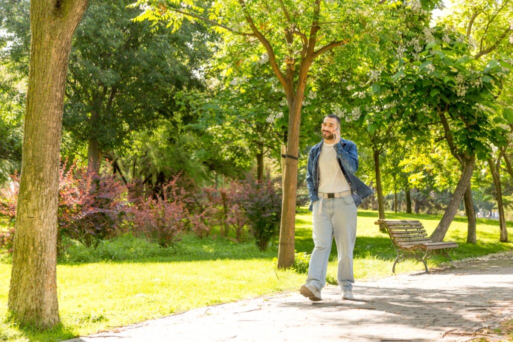 Young man walking through the park after Zoloft as made his day easier