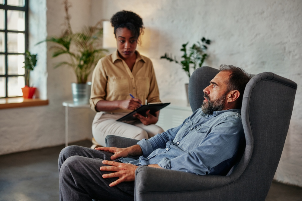 Depression therapist listens to patient in office