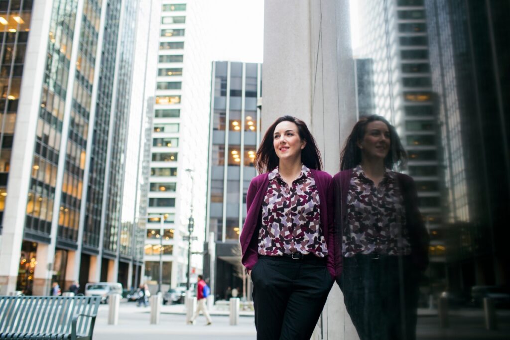 Woman standing in the middle of downtown Chicago, where Luxury Psychiatry Clinic offers TMS services