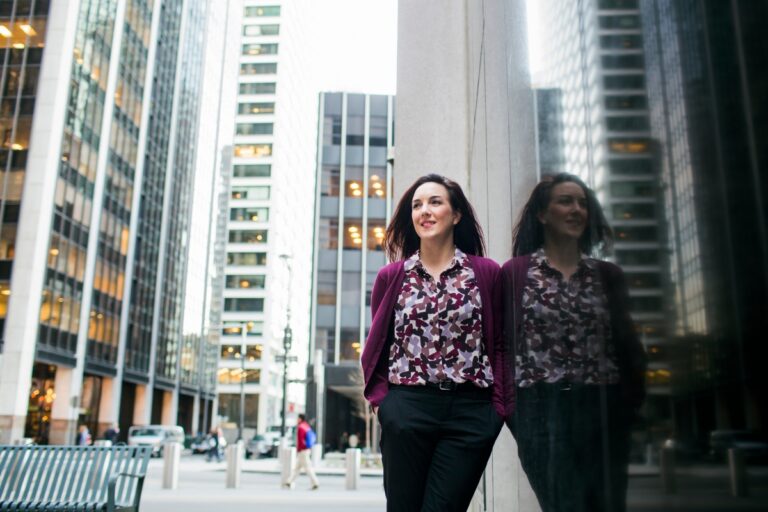 Woman standing in the middle of downtown Chicago, where Luxury Psychiatry Clinic offers TMS services