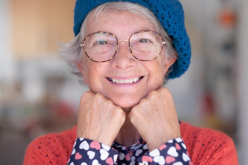 Elderly woman smiling because she takes care of her mental health while living in a retirement community in Florida.
