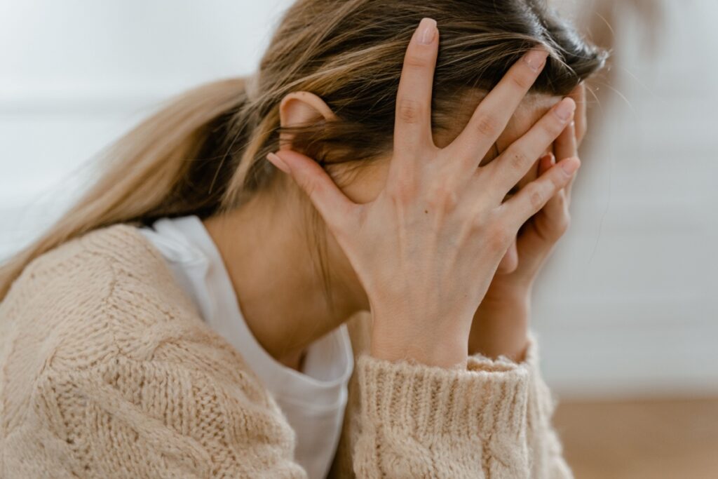 Person experiencing a panic attack with chest tightness, rapid heartbeat, and overwhelming anxiety.