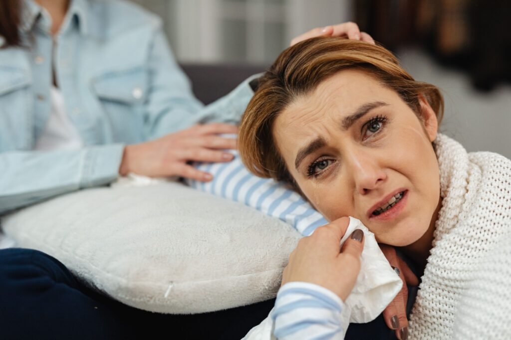 New mother experiencing symptoms of postpartum depression while caring for her baby.