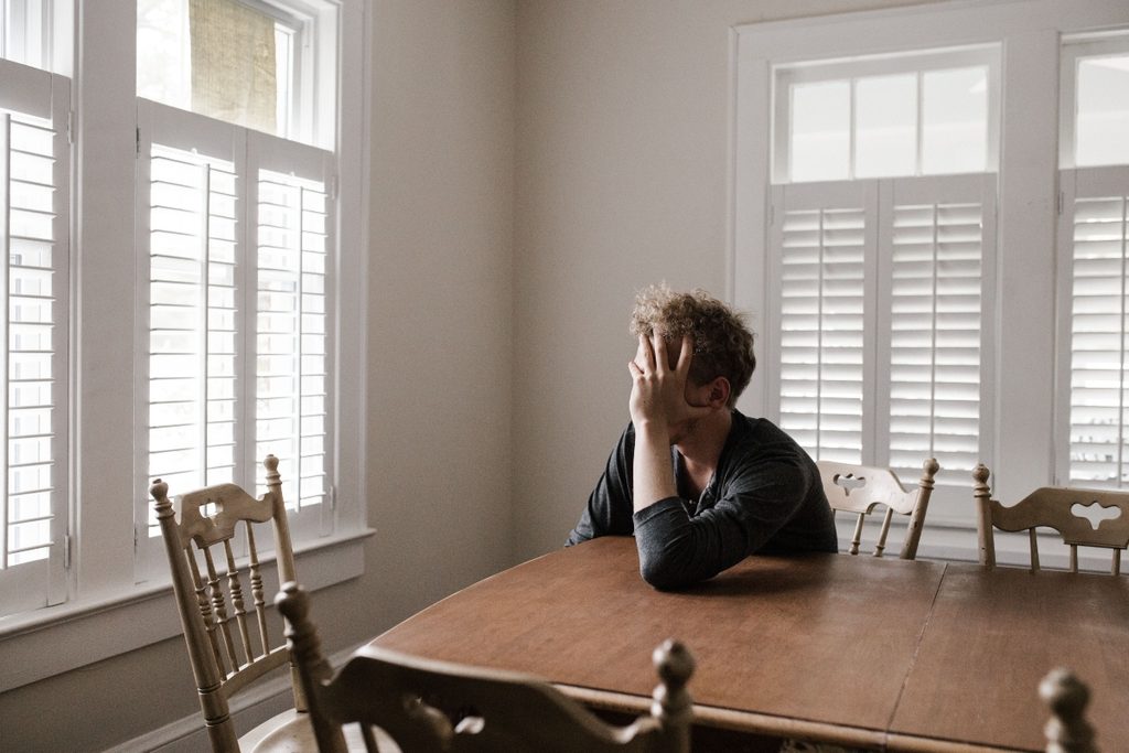 Person experiencing a stress-induced panic attack and symptoms of anxiety.